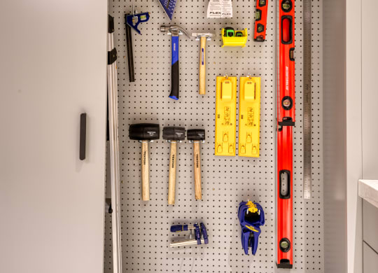a pegboard wall in a kitchen with tools on it
