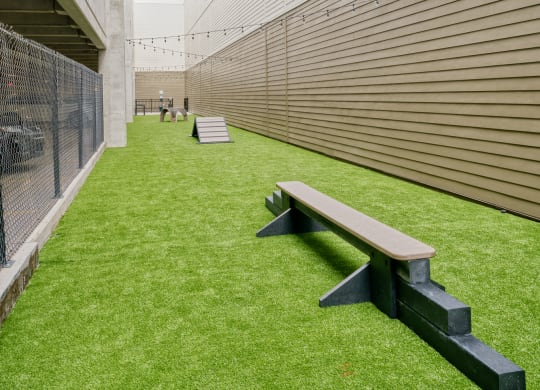 a courtyard with a bench and a fence
