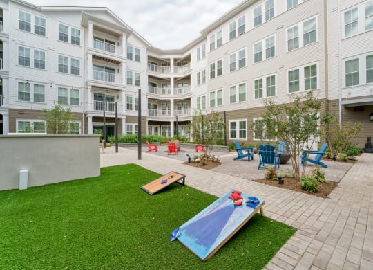 a courtyard with a surfboard in front of an apartment building