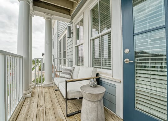 a porch with a couch and a table on it