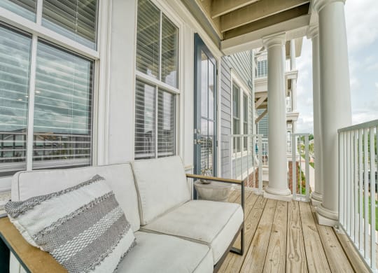 a porch with a couch and many windows
