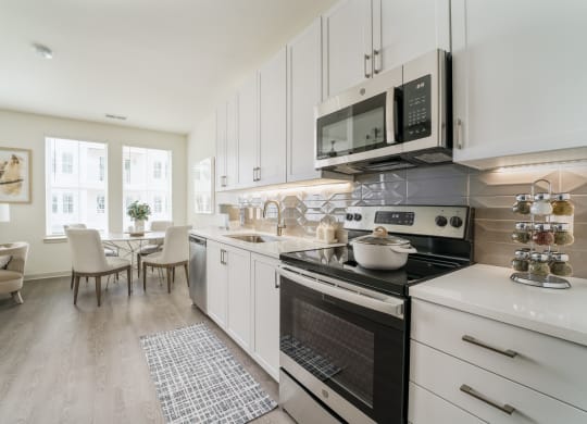 a kitchen and dining room with pink and white walls