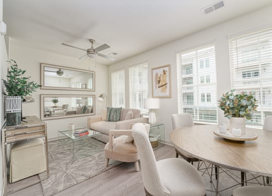 a living room with a round dining table and a couch
