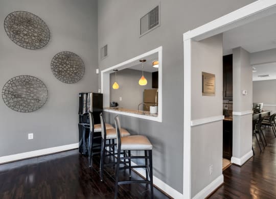 a bar area with stools and a refrigerator in a 555 waverly unit at Misty Ridge Apartments, Woodbridge, 22191