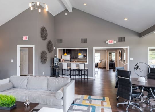 a living room with gray walls and a vaulted ceiling at Misty Ridge Apartments, Woodbridge