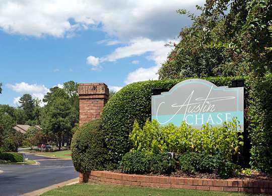 A sign that says property name at Austin Chase Apartments, Macon