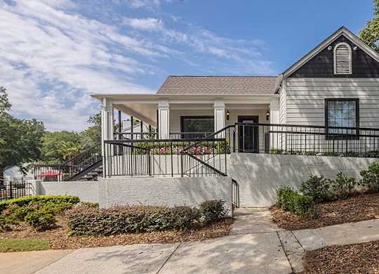 A house with a grey roof and a black fence.