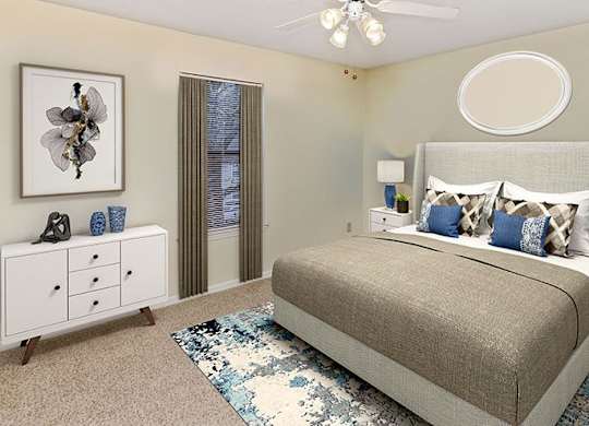 A bedroom with a bed, nightstand, and a dresser with a decorative item on top.
