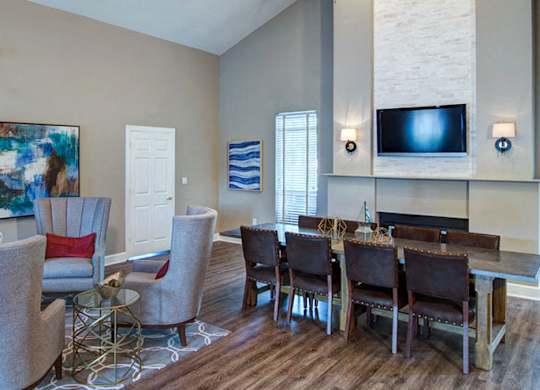 A living room with a grey sofa, a white armchair, and a wooden coffee table at Huntington Chase Apartments, Warner Robins, 31088