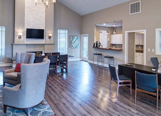 A living room with a grey sofa and a wooden floor at Huntington Chase Apartments, Warner Robins, Georgia