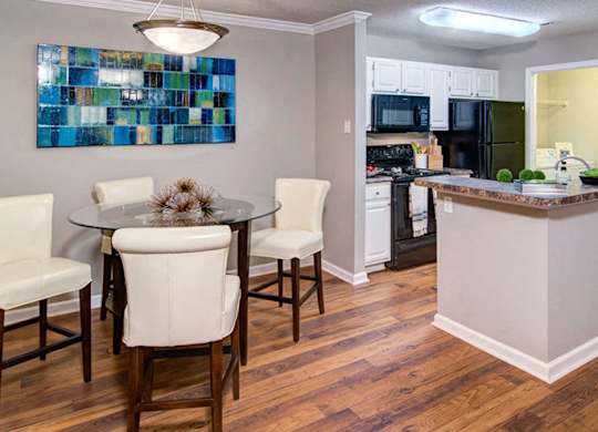 A kitchen with a dining table and chairs at Huntington Chase Apartments, Georgia 31088