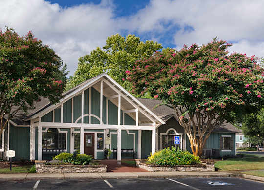 A building with a green roof and white columns.
