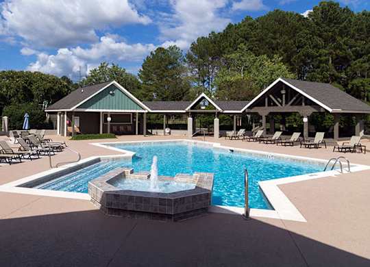 A pool with a fountain in the middle of it.