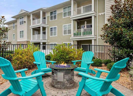 Fire pit seating area with turquoise chairs at Colony at Centerpointe Apartments, Midlothian, VA 23114