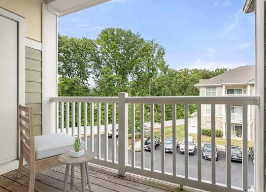 Balcony with seating and tree views at Colony at Centerpointe Apartments, Midlothian, Virginia