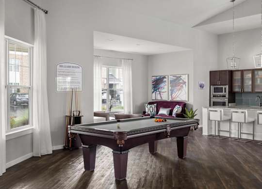 Billiards lounge with pool table and open kitchen at Colony at Centerpointe Apartments, Midlothian, VA