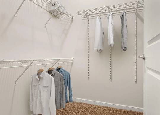Walk-in closet with wire shelving and hanging rods at Colony at Centerpointe Apartments, Midlothian, 23114
