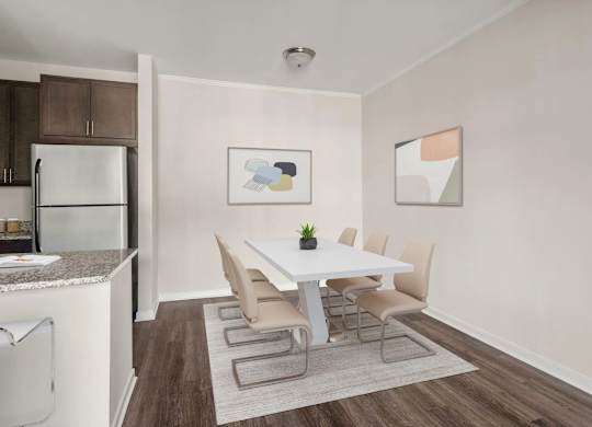 Dining area with modern white table and upholstered chairs at Colony at Centerpointe Apartments, Virginia