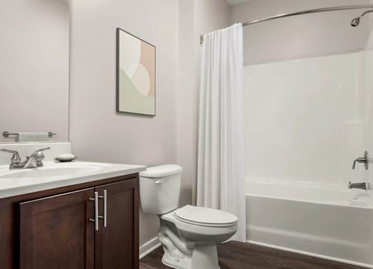 Bathroom with white tub and shower curtain at Colony at Centerpointe Apartments, Midlothian, Virginia