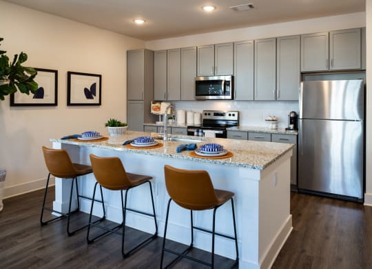 a view of a kitchen with a bunch of stars on the wall at The Quincy Apartments, Acworth, 30102