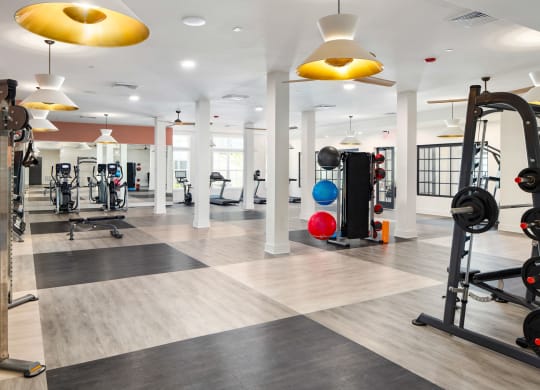 a gym with colorful lights on the ceiling at The Quincy Apartments, Georgia, 30102