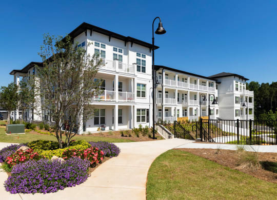 a sidewalk in front of an apartment building at The Quincy Apartments, Georgia, 30102