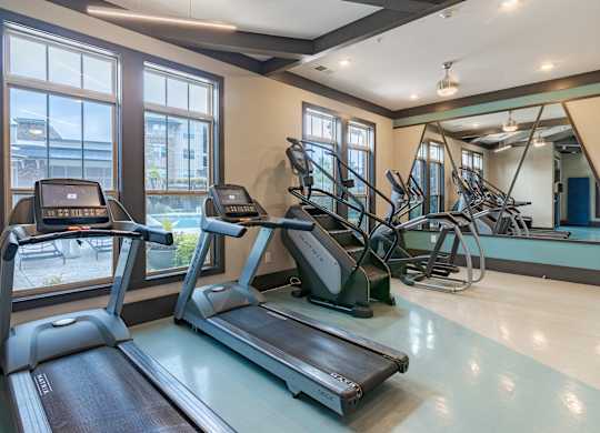 A gym with treadmills and exercise bikes.