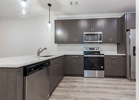 A modern kitchen with a stainless steel dishwasher and oven.