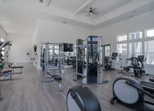 A spacious gym with a variety of equipment including treadmills, weights, and exercise machines.