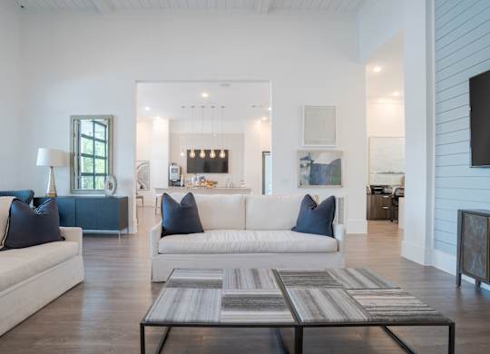 A modern living room with a white couch and a coffee table.