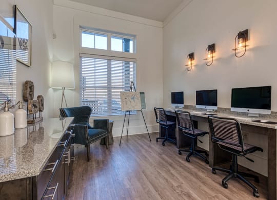 a conference room with desks and chairs and a table with a computer at Retreat at Arden Farms, Arden North Carolina