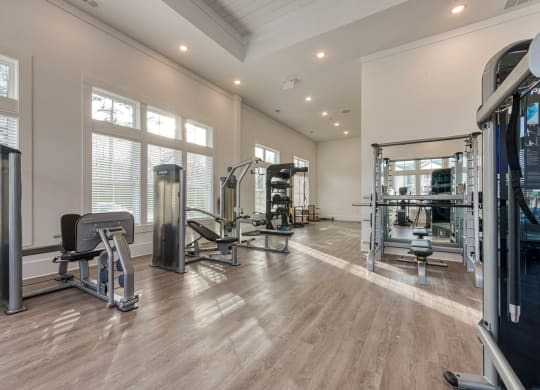 a gym with weights and mirrors on the floor and windows at Retreat at Arden Farms, Arden, NC 28704