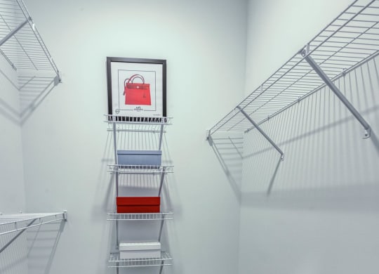 an empty closet with empty shelves in a room with white walls and carpet at Retreat at Arden Farms, Arden