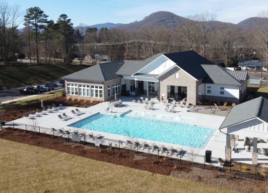 arial view of a pool in front of a house at Retreat at Arden Farms, Arden, NC