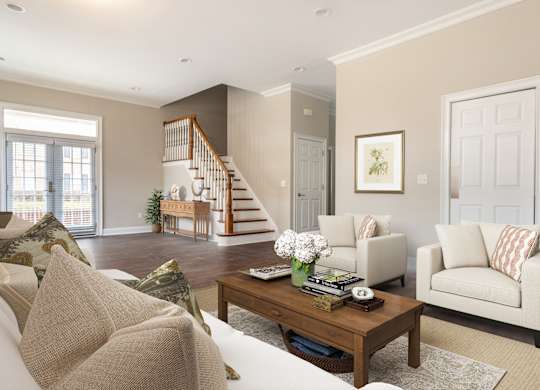 A living room with a staircase and a couch.