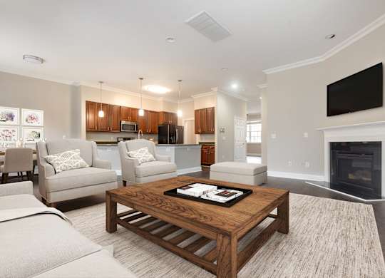 A modern living room with a fireplace and a flat screen TV mounted on the wall.