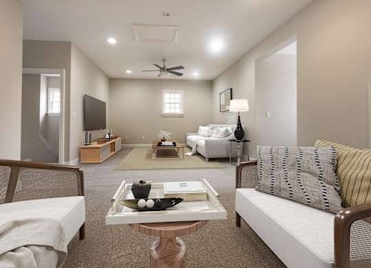 A living room with a couch, chair, and coffee table.