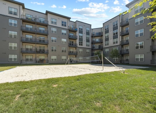 a volleyball court at the flats at big tex apartments in san antonio, tx at Rivergate, Woodbridge, 22191