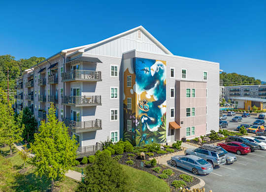 A large white building with a mural on the side.