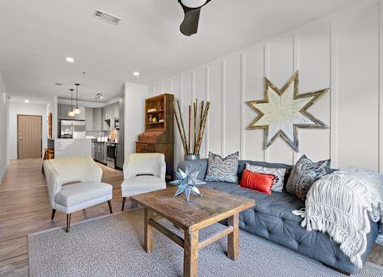 A living room with a grey couch and a wooden coffee table.