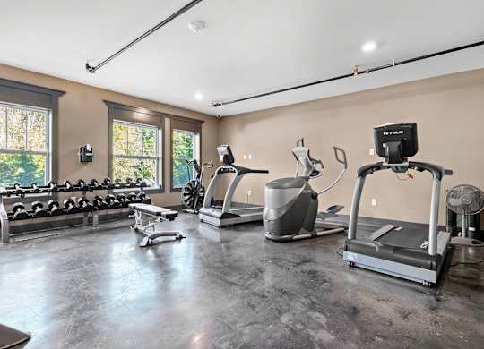 A spacious home gym with a variety of exercise equipment.