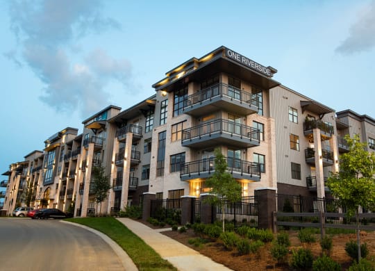 an apartment building with a sidewalk in front of it  at One Riverside Apartments, Chattanooga, TN, 37403