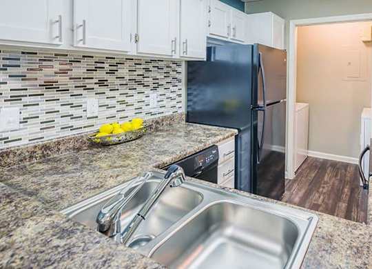 A kitchen with a granite countertop and stainless steel appliances. at The Colony at South Park, Aiken, SC, 28903