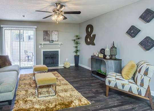 A living room with a fireplace and a couch. at Woodwinds, Aiken