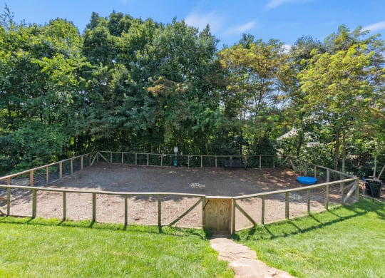 a fenced in area with trees in the background at Skyloft, Asheville