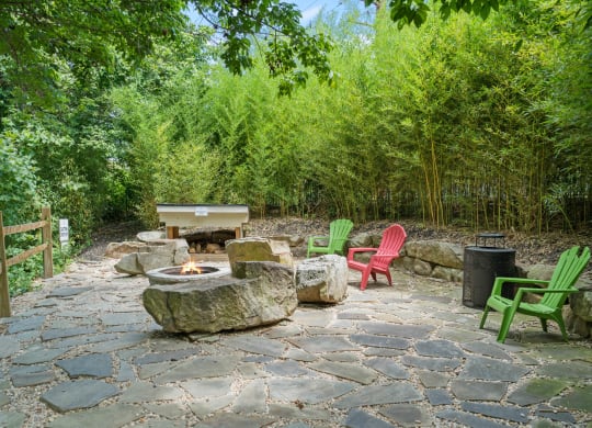 a stone patio with chairs and a fire pit at Skyloft, North Carolina