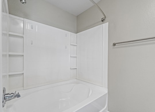 a white bathroom with a tub and shower and a sink at SomerHill Farms Apartments, Virginia