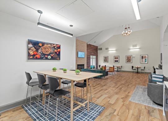 a dining room with a table and chairs and a living room at SomerHill Farms Apartments, Gainesville, 20155