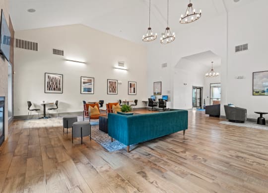 a living room with a blue couch in the middle at SomerHill Farms Apartments, Gainesville, VA 20155