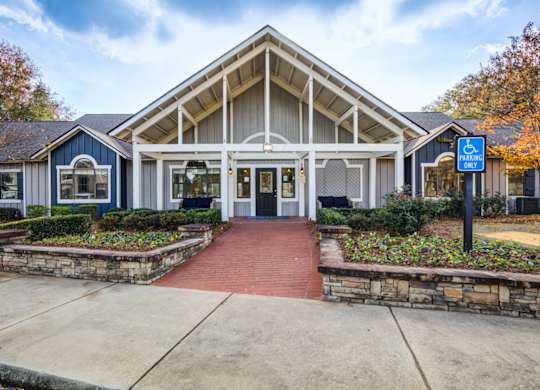 A building with a blue handicap sign in front at Southland Station Apartments in Warner Robins, GA